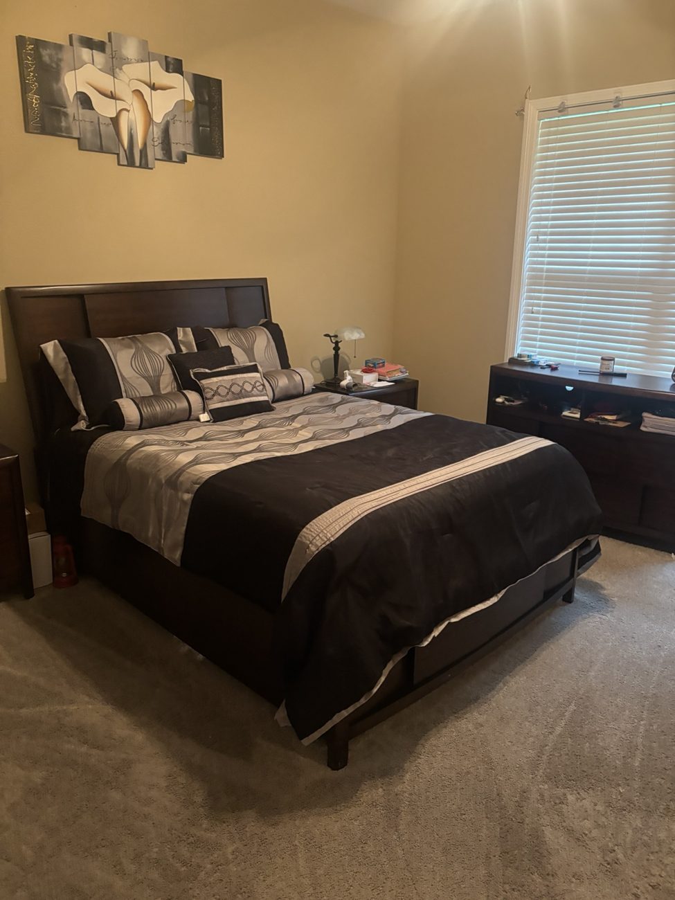 Bedroom with bed made and floor tidied after service