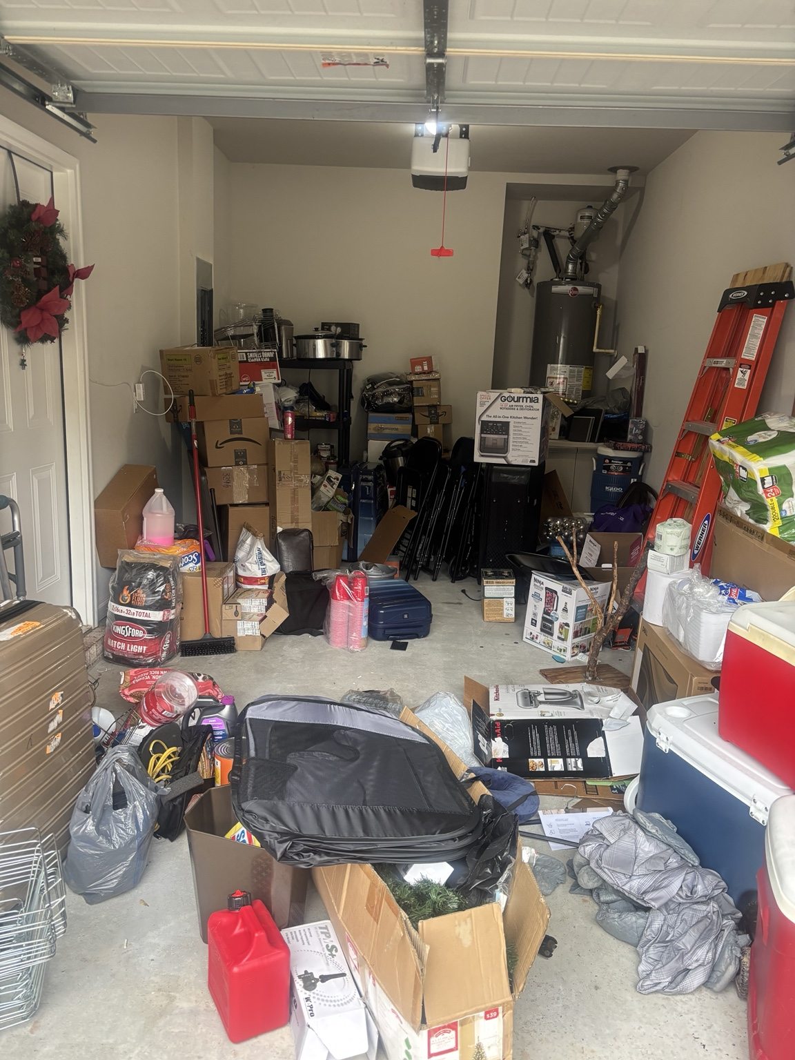Garage before organization with boxes, equipment, and items crowding the floor