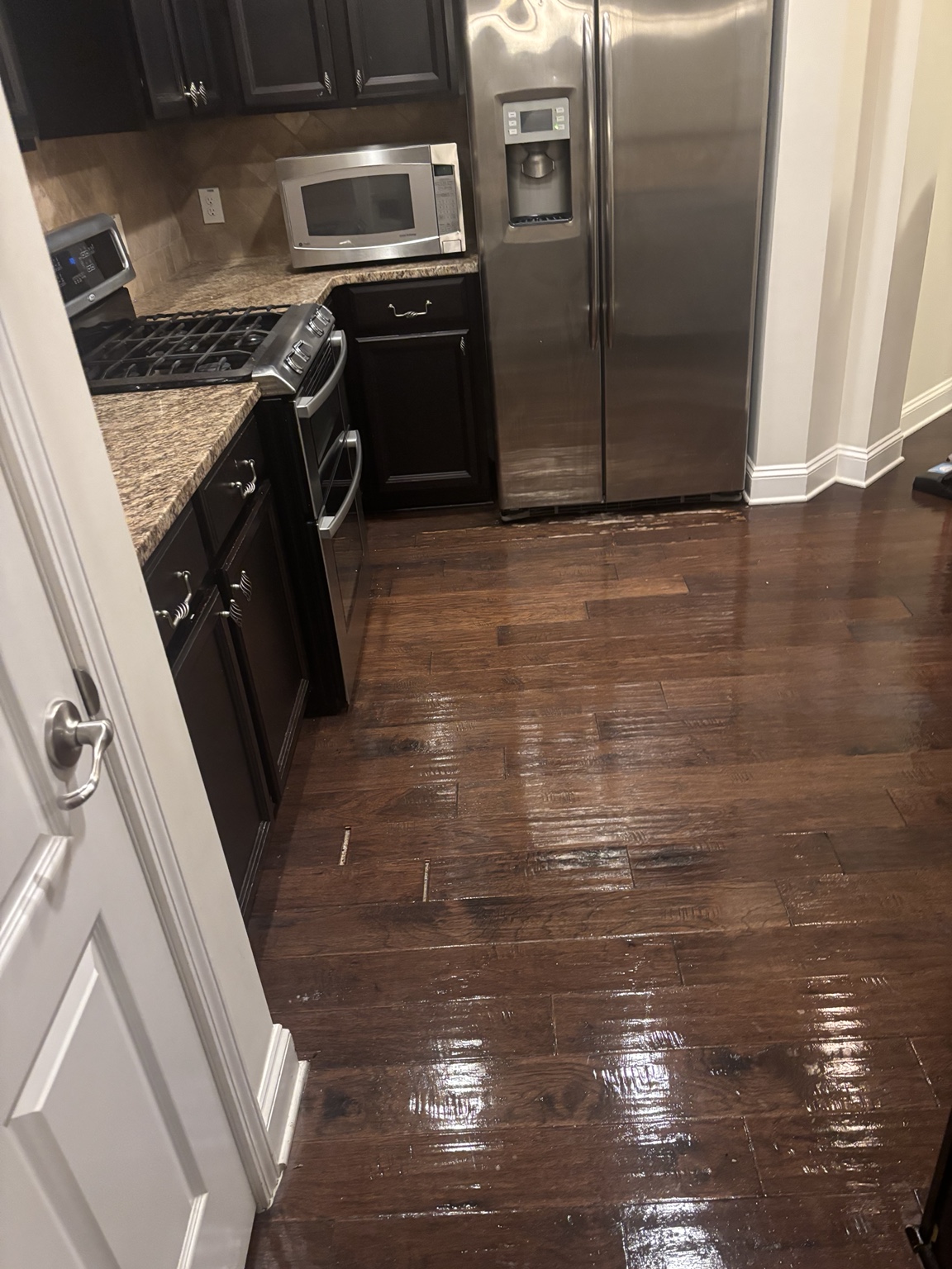 Clean kitchen and dark wood floors after service