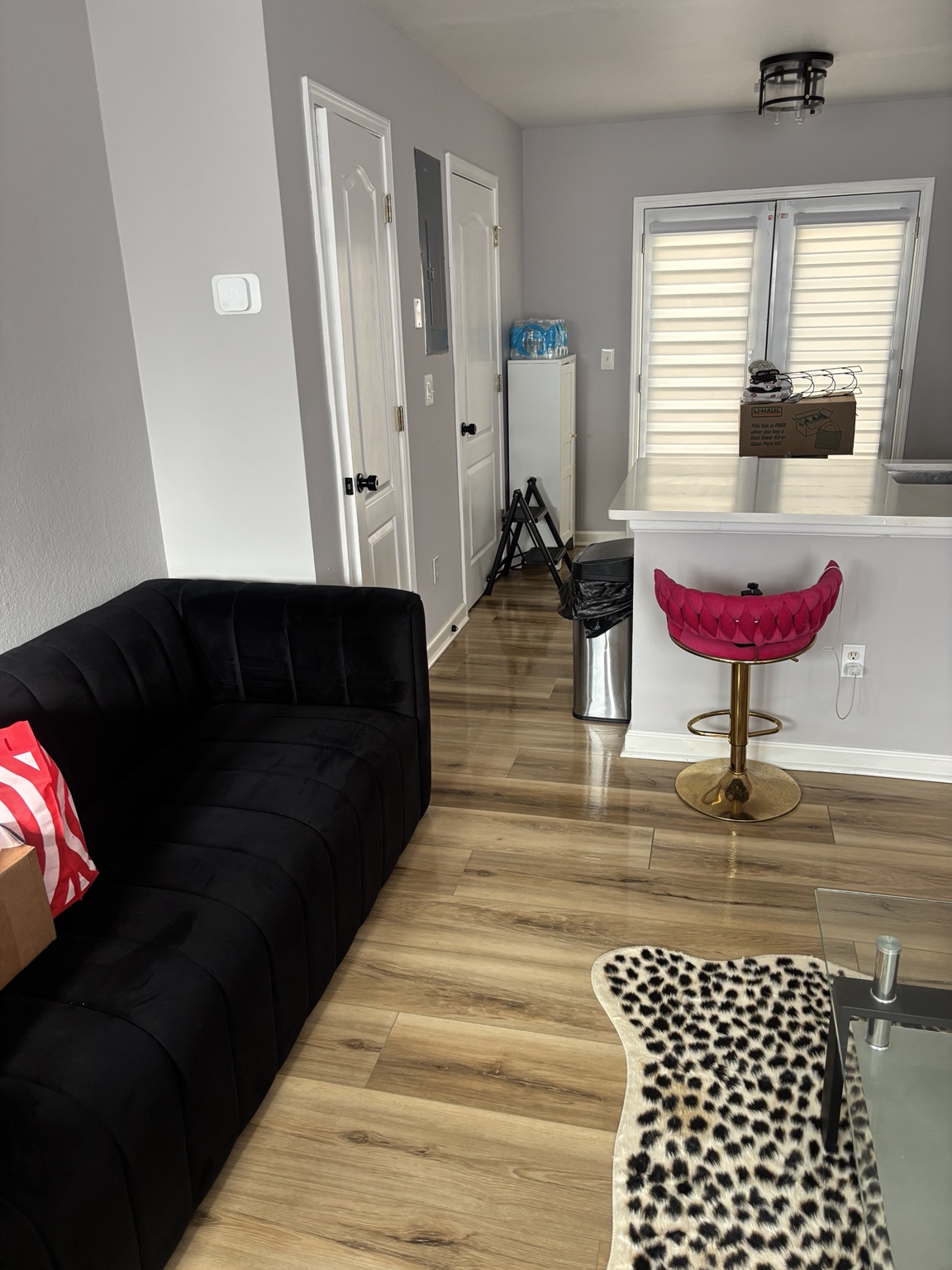 Another angle of a clean living room and kitchen area